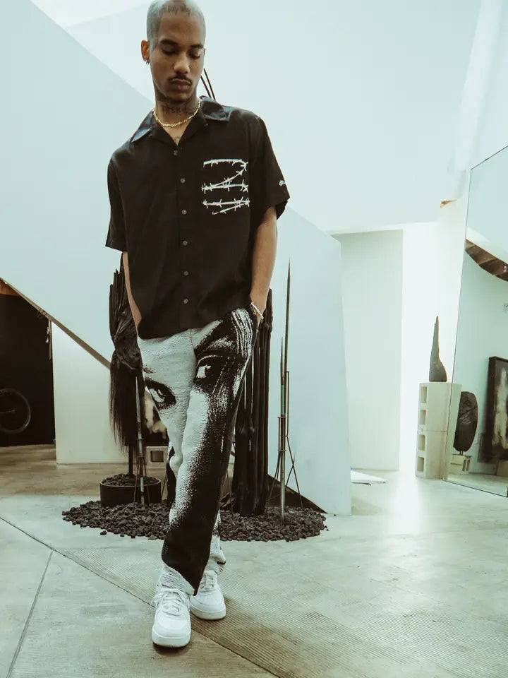 Barbed Wire Pocket Shirt (Black) worn by a model, featuring white barbed wire print across the chest pocket.