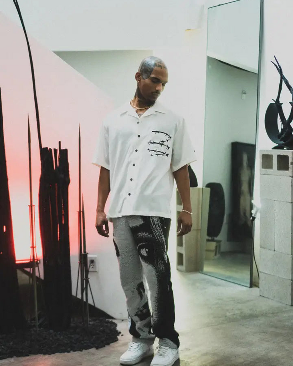 Barbed Wire Pocket Shirt (Ivory), an ivory short-sleeve button-up with barbed wire on the pocket, worn by a model.