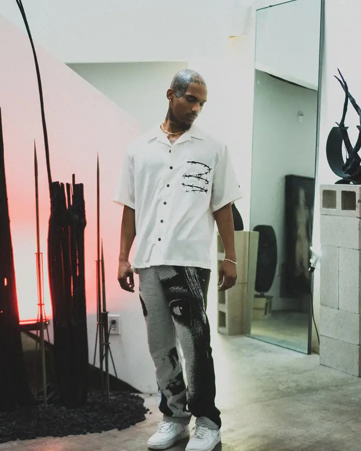 Barbed Wire Pocket Shirt (Ivory), an ivory short-sleeve button-up with barbed wire on the pocket, worn by a model.
