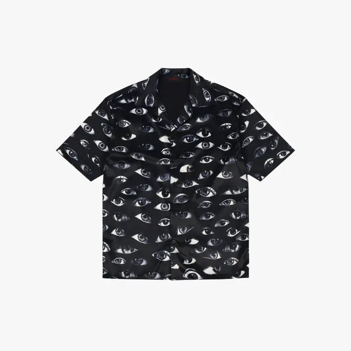 Paranoid Short Sleeve Button Up, flat product shot of a black collared shirt with an all-over human eye print.